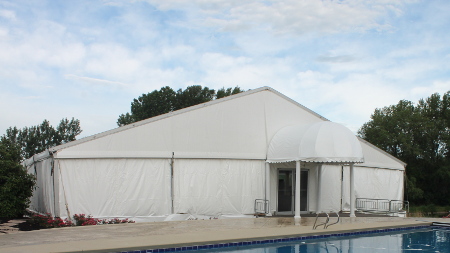 Image of tent set up on decking layed over empty pool