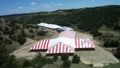 ariel view of 86 X red and white T tent with other tents