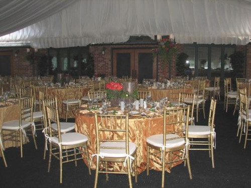 view of tables and chairs on black carpet
