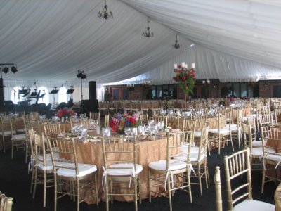 Interior view of completed tent set with decorations and set for a wedding